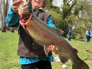 boy holding huge trout at TroutFest